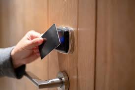 Hotel key card being used to unlock a modern door lock system.